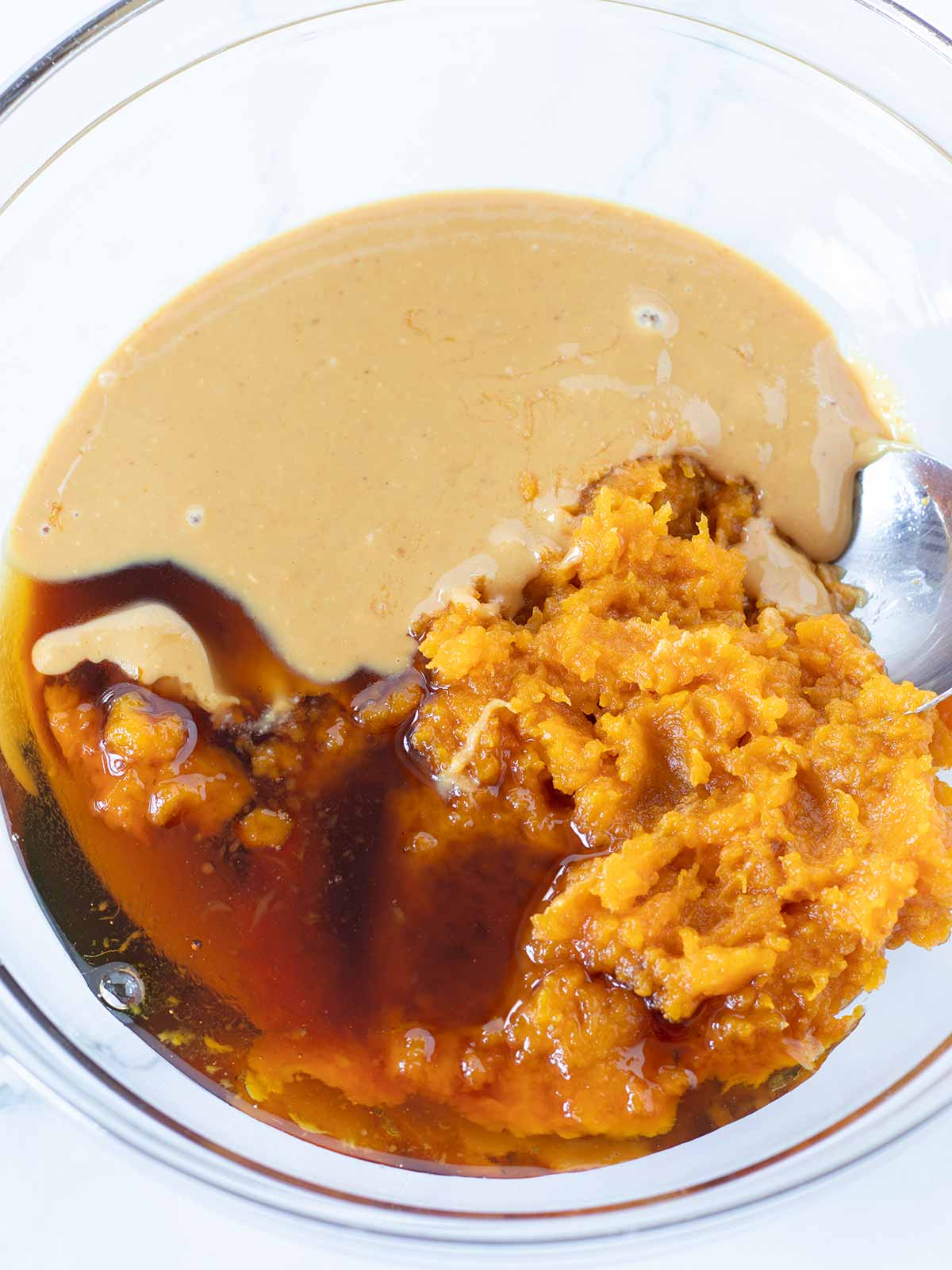 Wet ingredients mixed in a bowl for pumpkin energy bites.