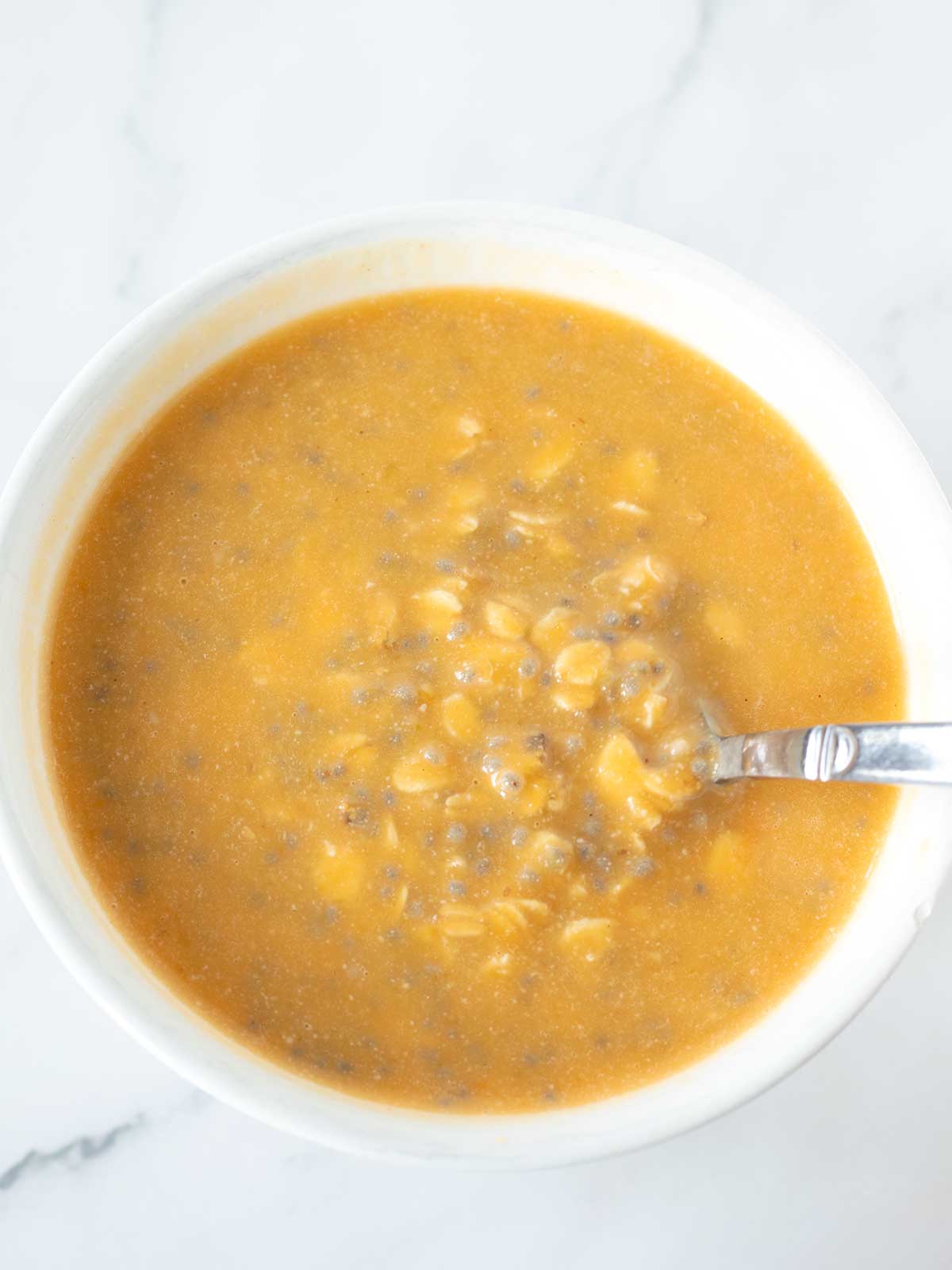 Meal prep of cold overnight pumpkin oatmeal with chia seeds and dairy-free milk.