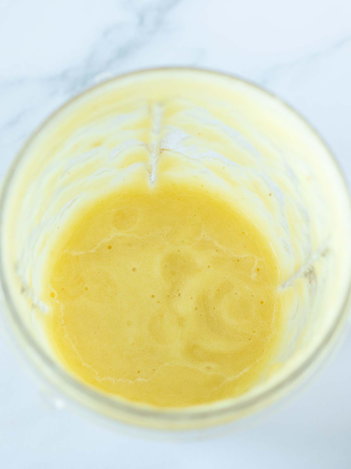 Blended pineapple in blender cup.