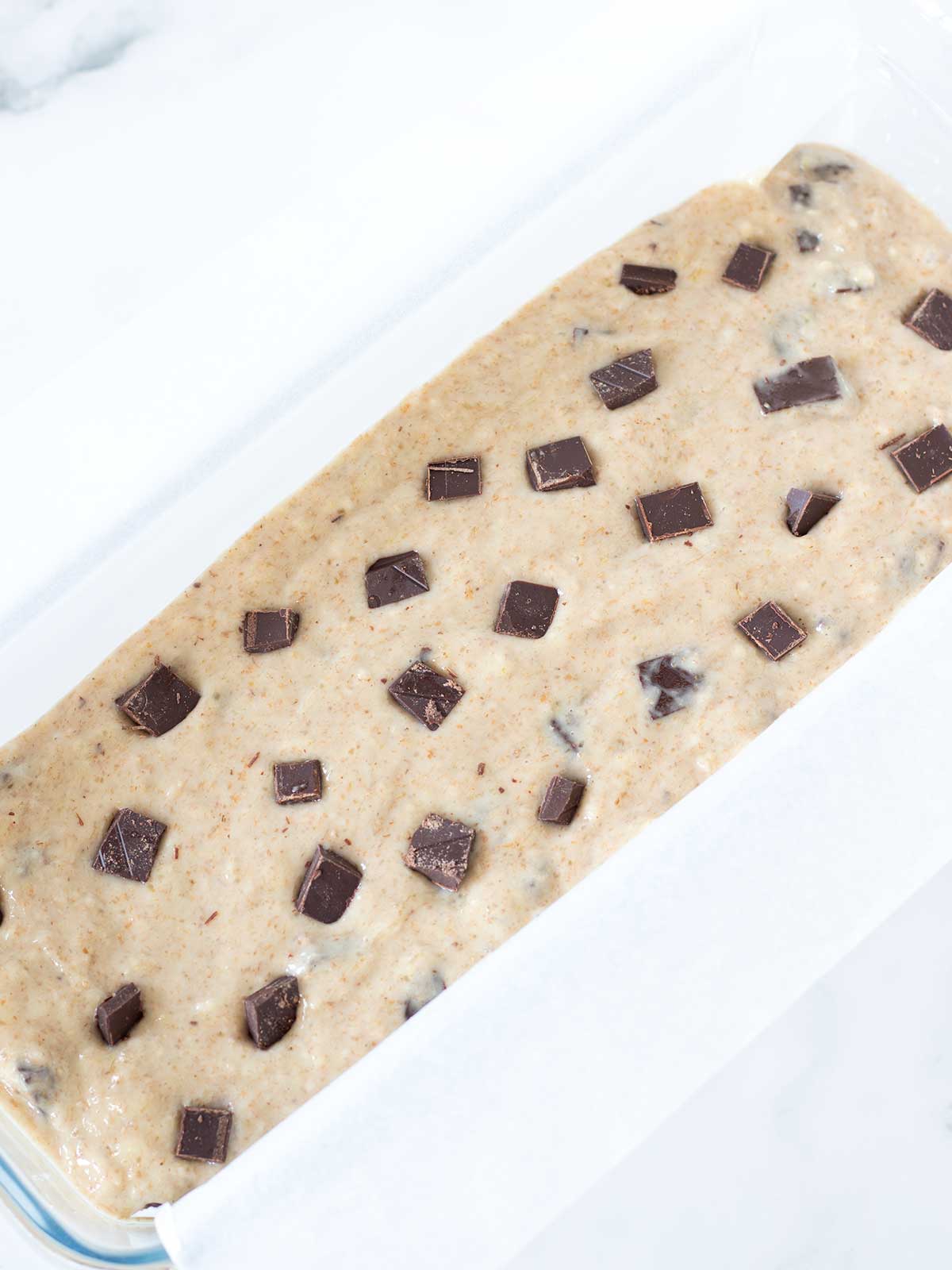 Chocolate chunk banana loaf prepared for baking.
