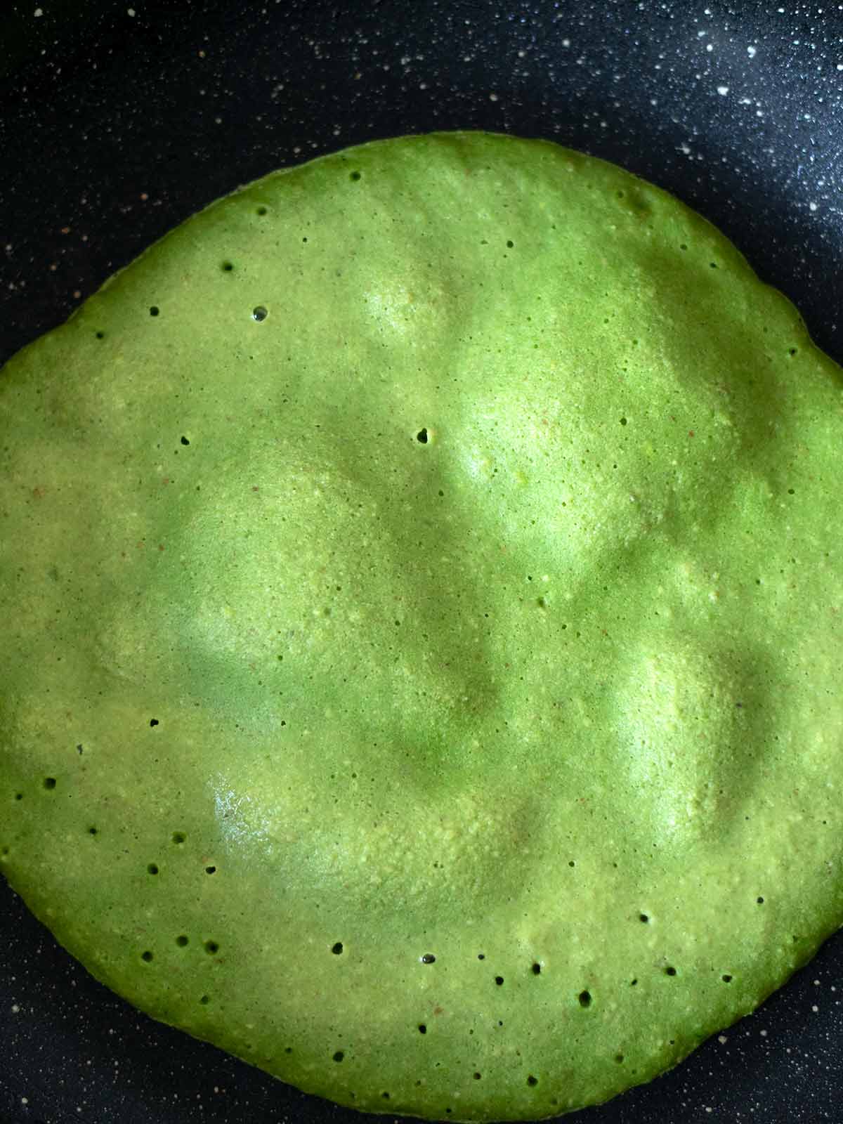 Cooking plant-based green spinach tortilla.
