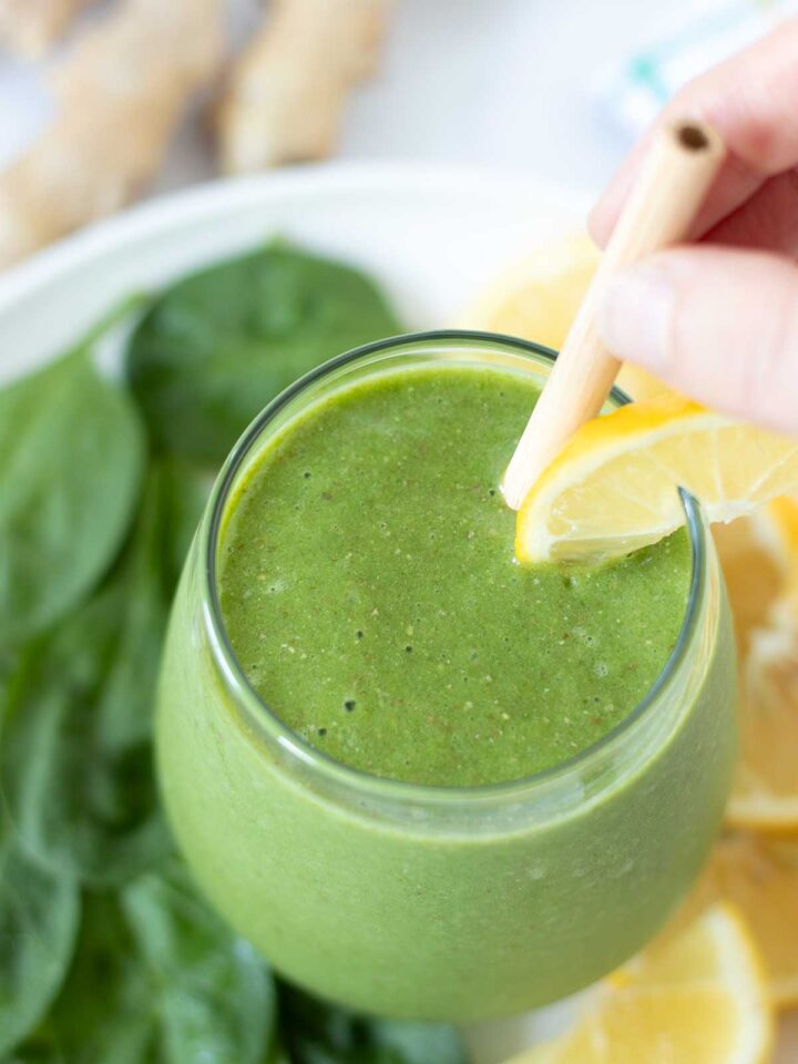 Vegan green spinach ginger smoothie with lemon and banana.