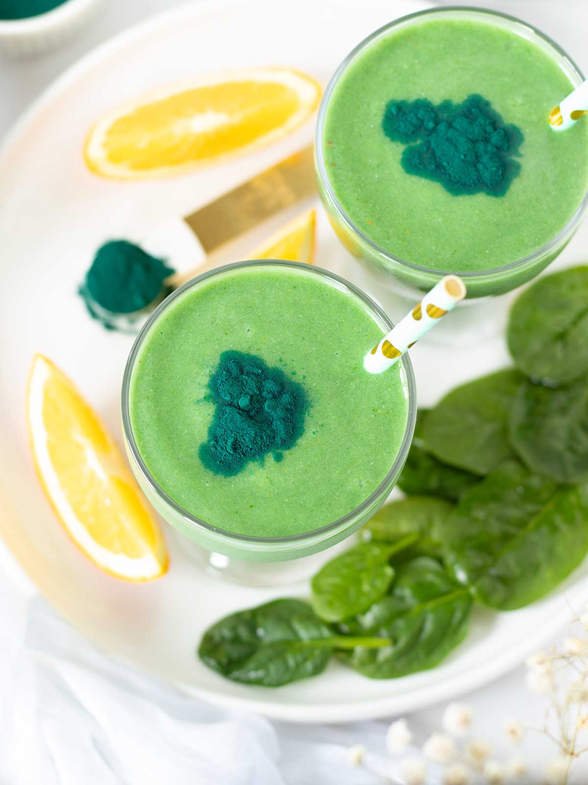 Green spirulina smoothie (high-protein morning drink) with banana, avocado, pineapple and orange juice.