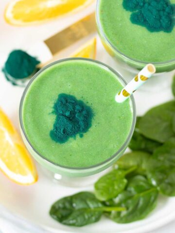Green spirulina smoothie (high-protein morning drink) with banana, avocado, pineapple and orange juice.