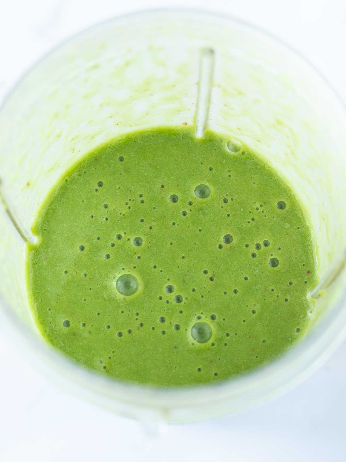 Creamy green smoothie with ginger, lemon, and spinach.