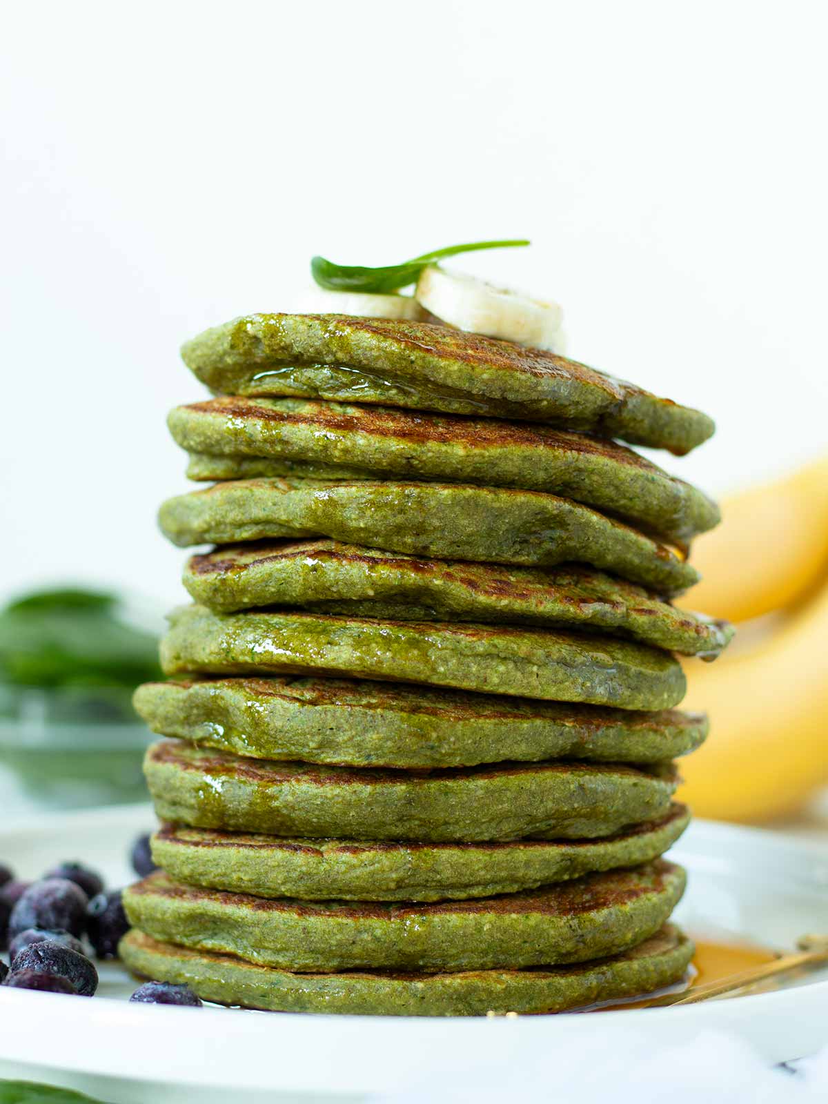 Vegan spinach banana pancakes with green color.