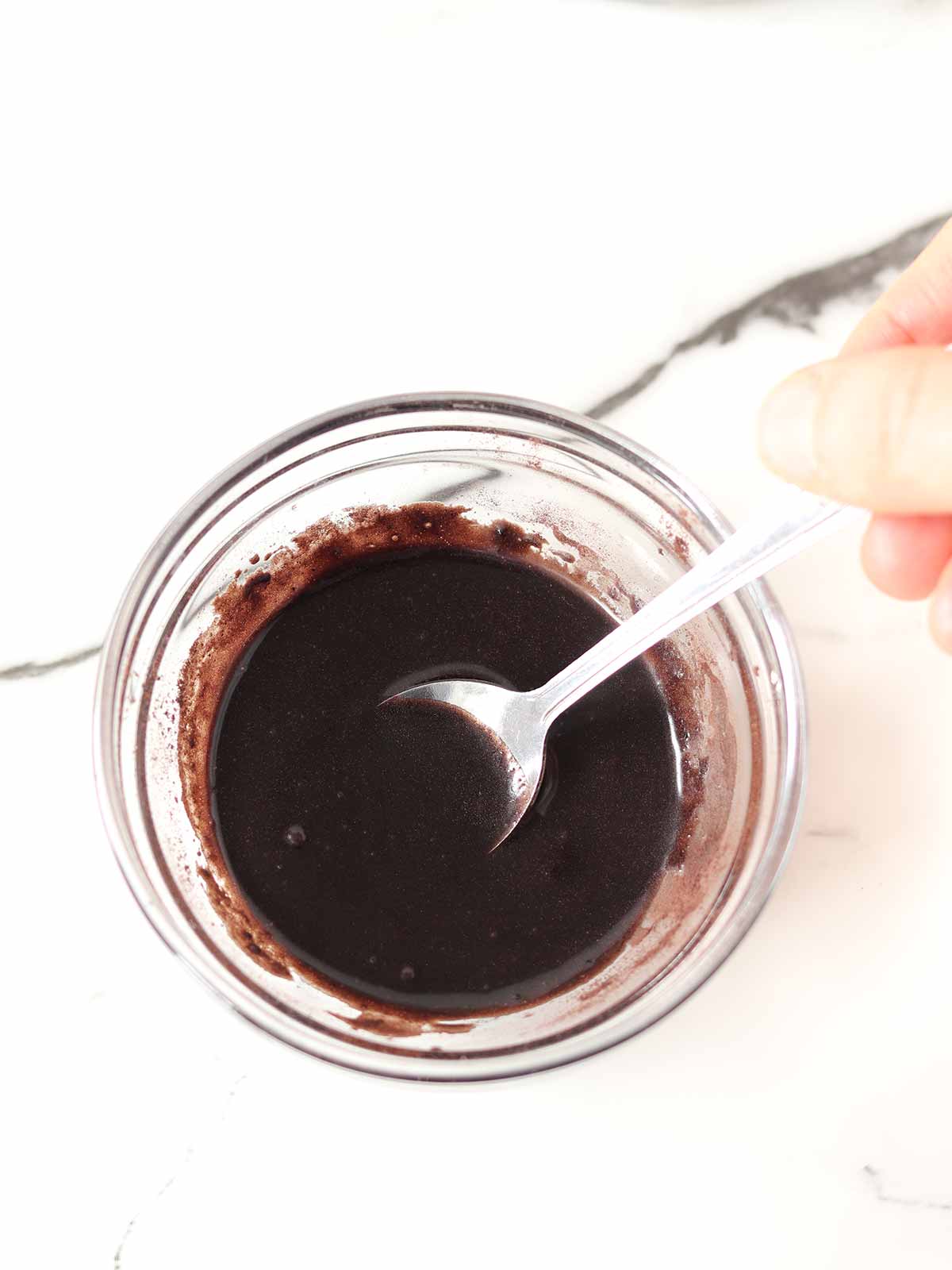 Homemade chocolate sauce with maple syrup and cocoa powder.