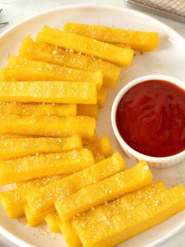 Crispy baked polenta frita sticks.