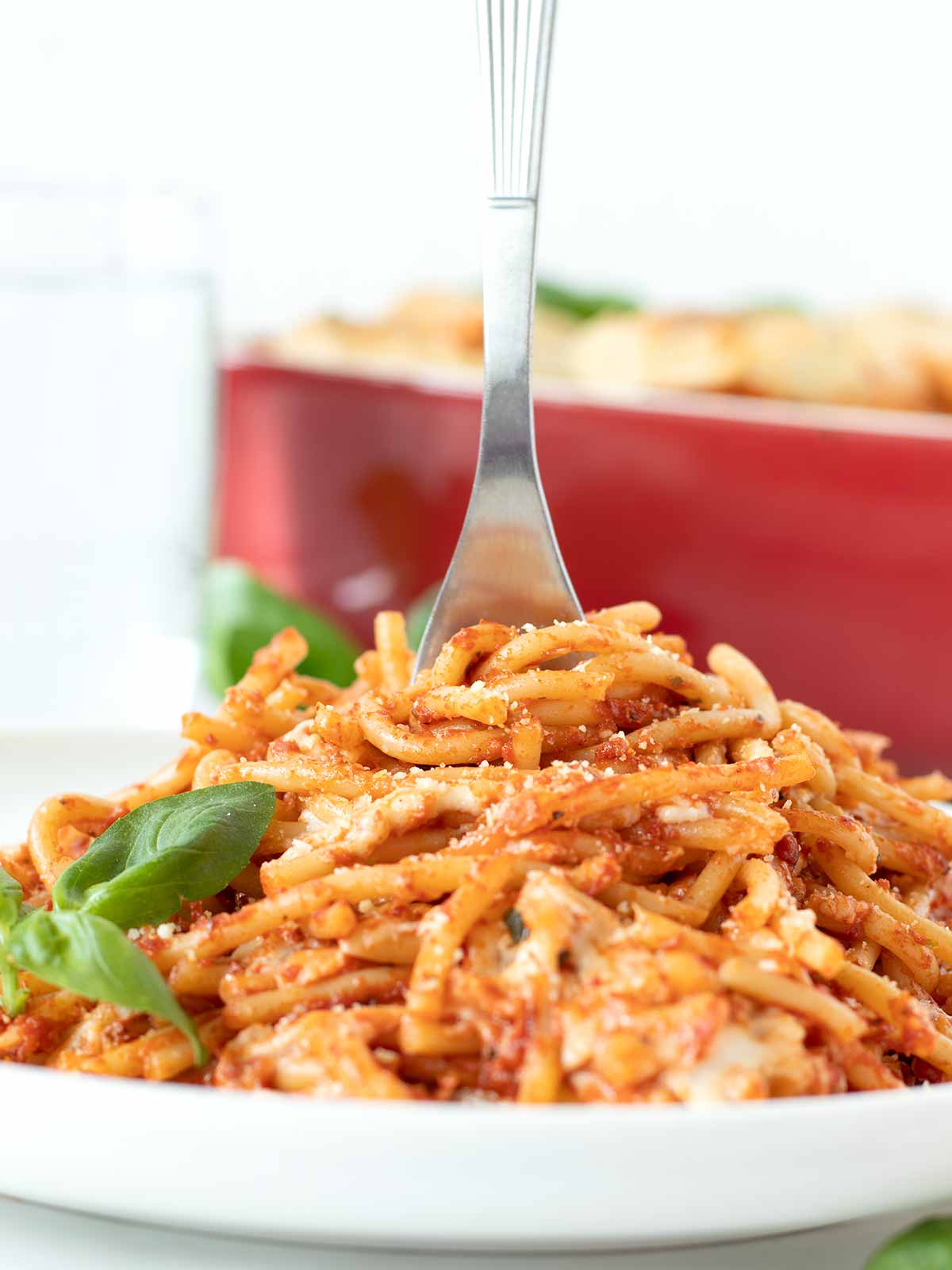 Meatless vegan baked spaghetti with creamy homemade mozzarella cheese and tomato sauce.