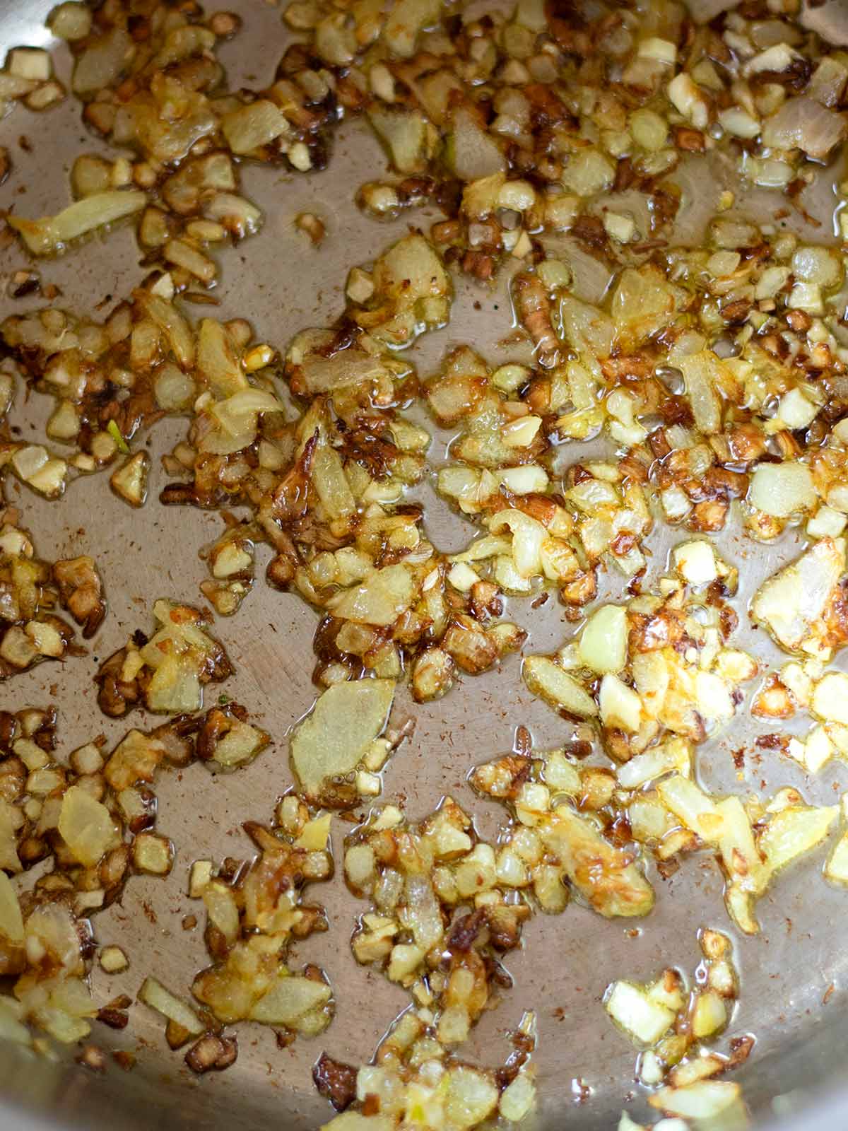 Cooking onion and garlic for spinach broccoli soup.