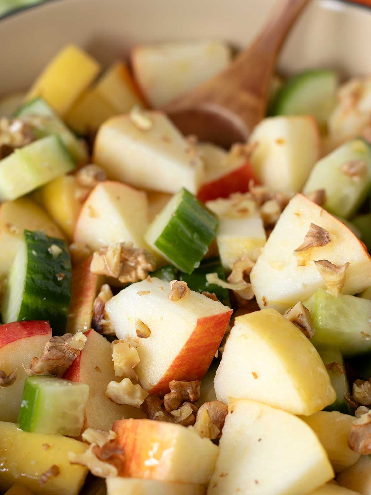 Vegan apple and cucumber salad with walnuts and simple lemon olive oil dressing.