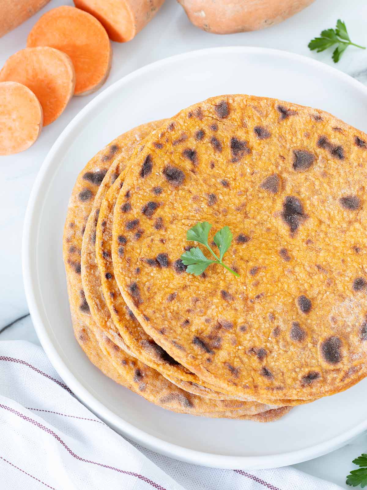 Stack of homemade vegan tortillas with mashed sweet potato.