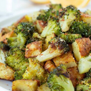 Oven roasted potatoes and broccoli as a vegan side dish or appetizer.