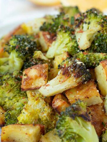 Oven roasted potatoes and broccoli as a vegan side dish or appetizer.