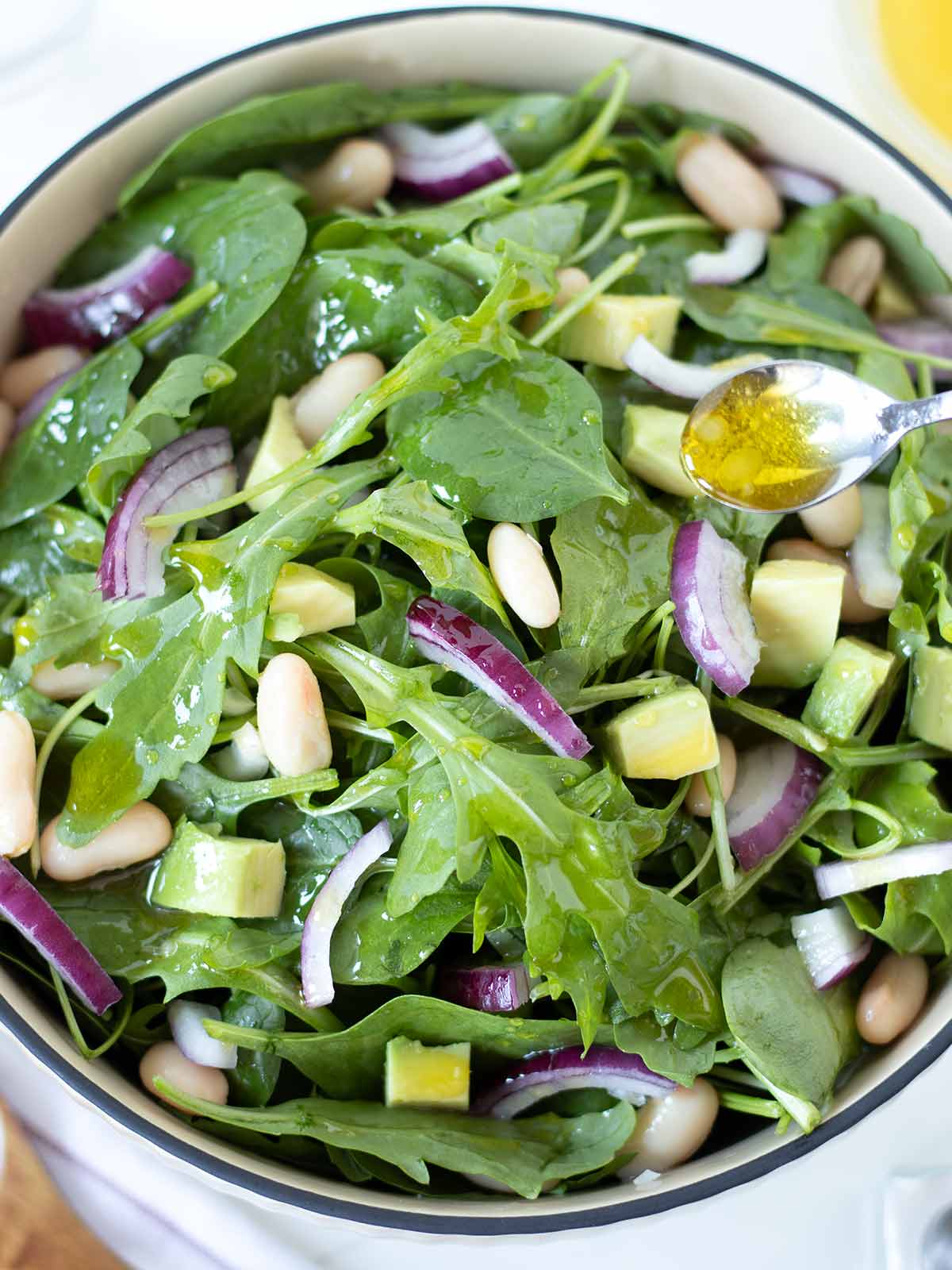 Spinach arugula salad with simple lemon olive oil dressing.