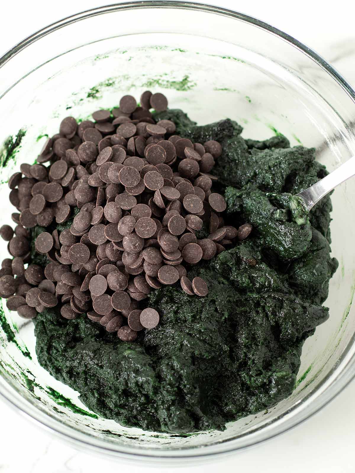Spirulina cookie batter with chocolate chips.