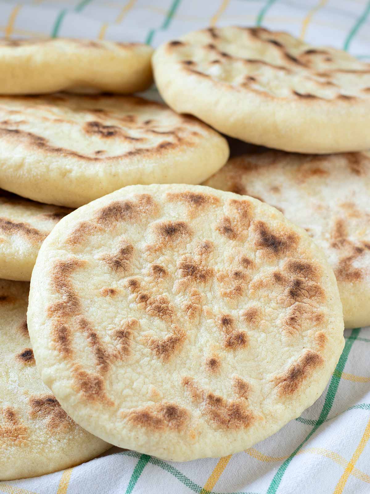 Easy vegan pita bread in kitchen towel.