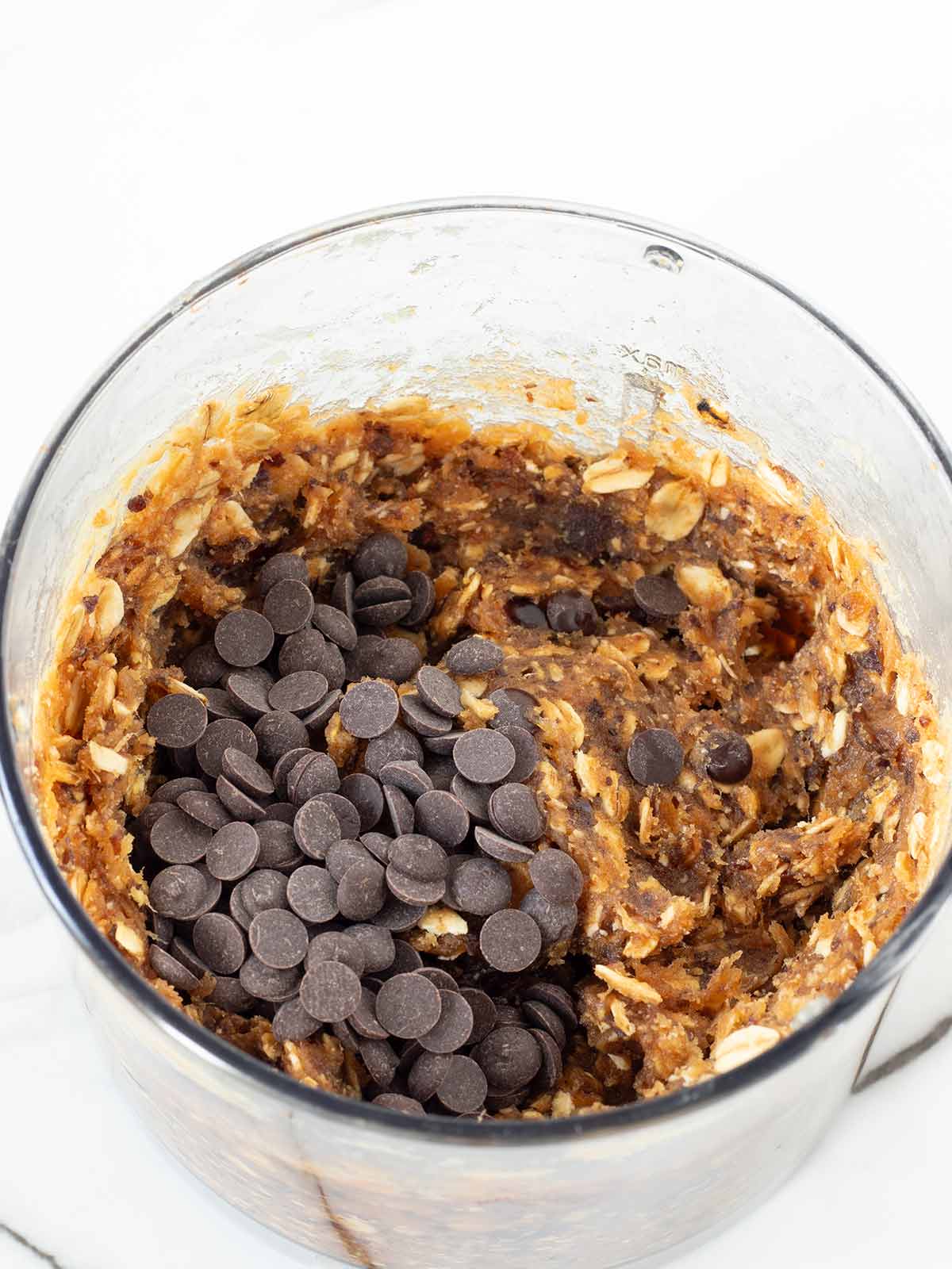 Chocolate chips in oatmeal peanut butter energy bites dough.