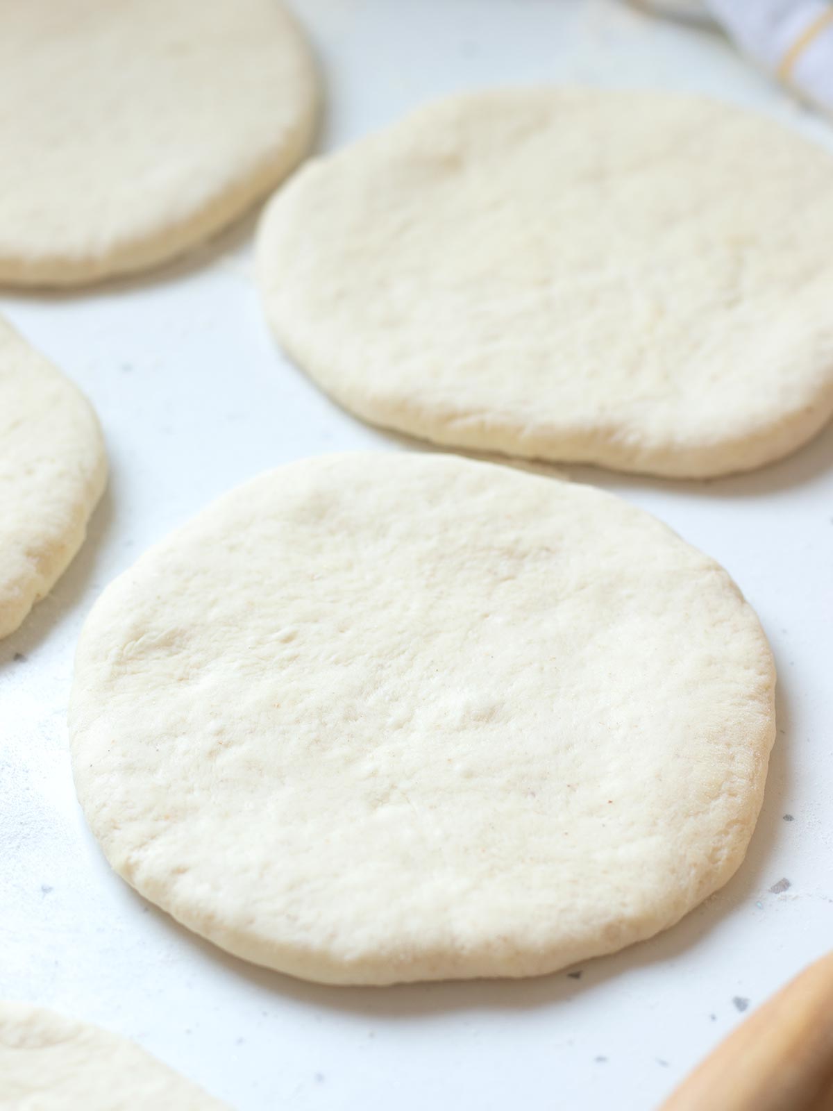 Rolling dough for pita bread.