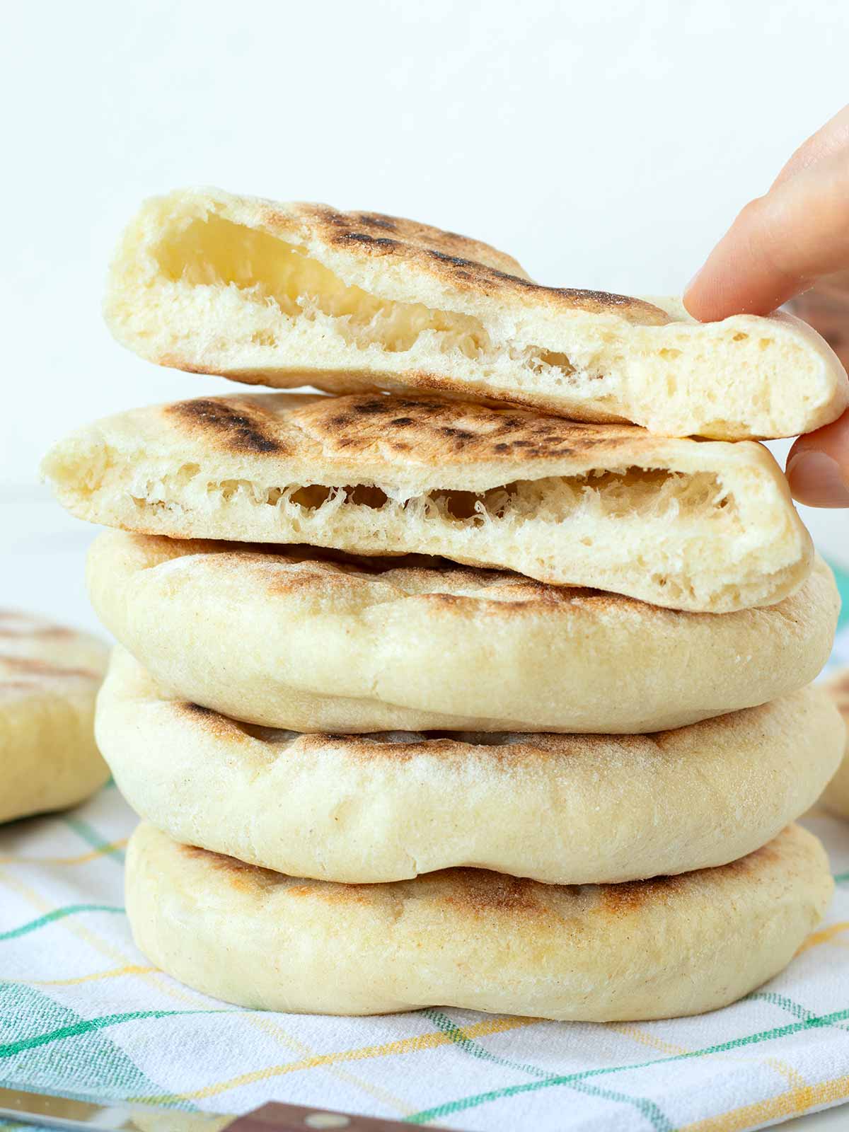 Stack of soft and fluffy homemade vegan pita bread.