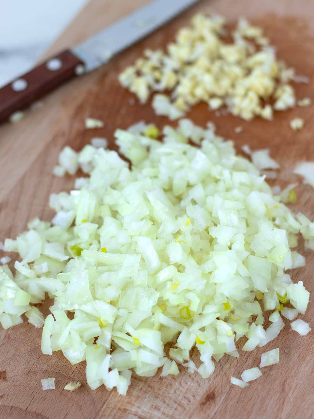 Chopped onion and garlic for meat-free jackfruit patties.