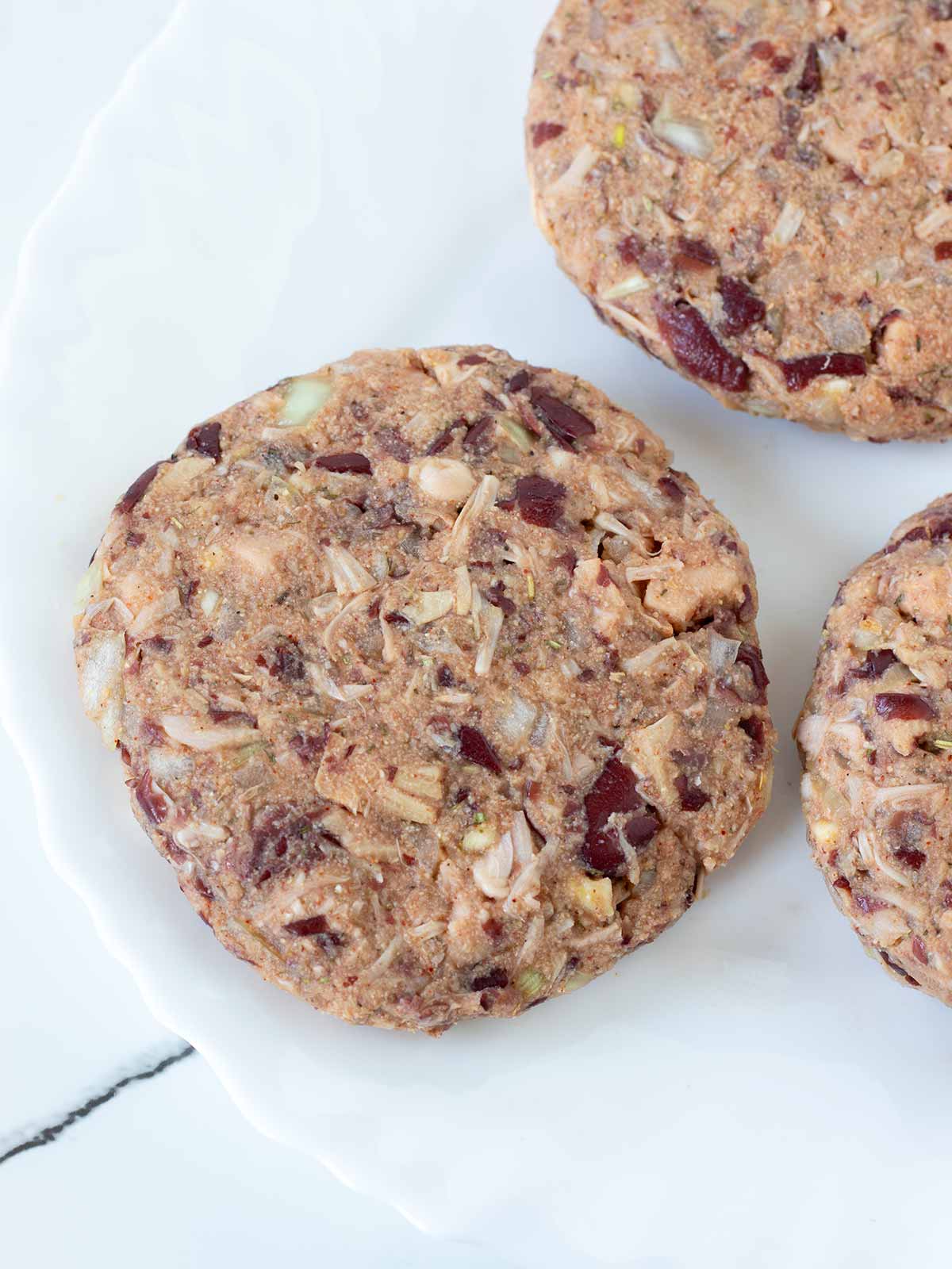 Plant-based jackfruit burger patties prepared for cooking.