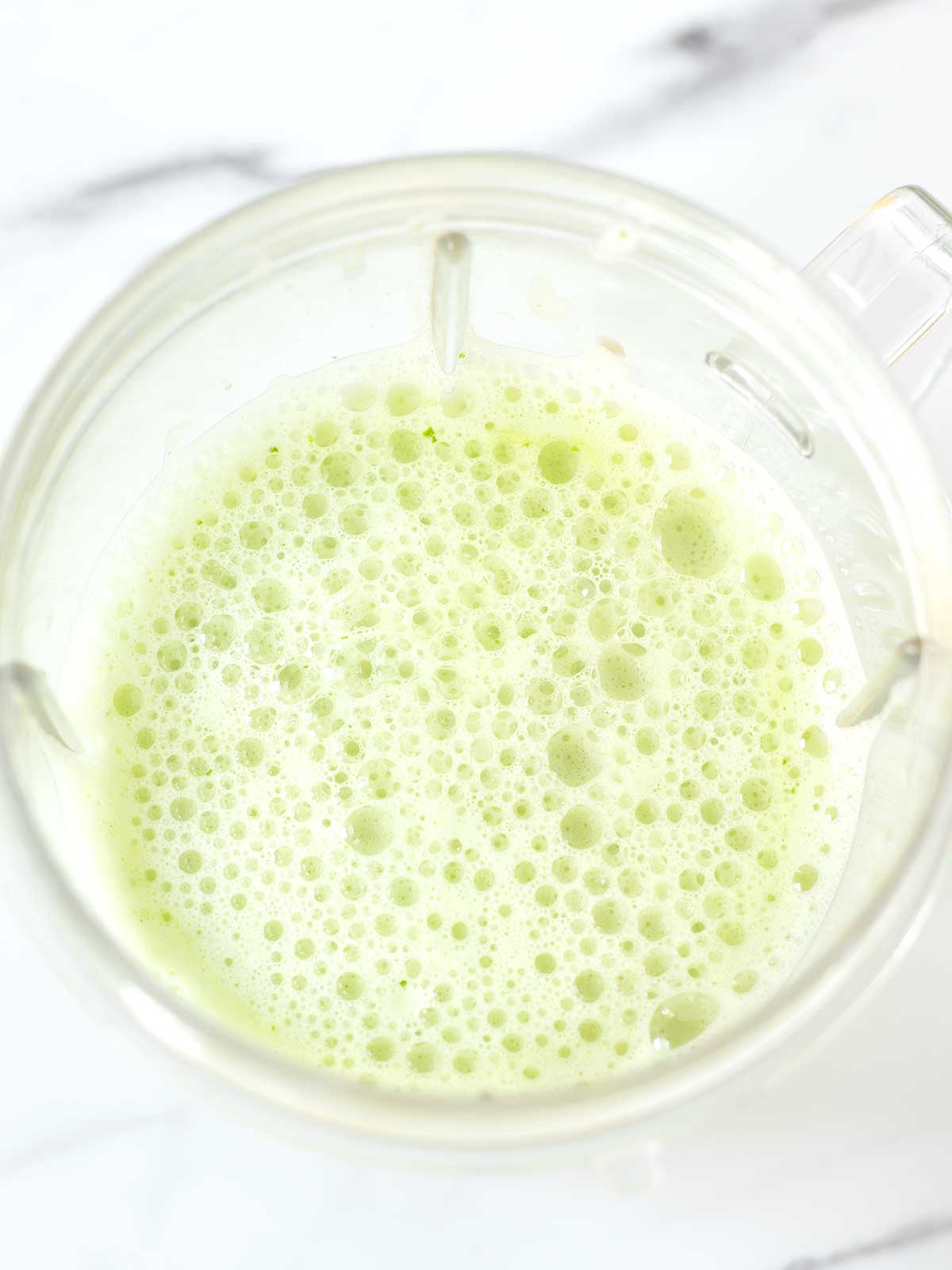 Frothy lemon mint smoothie drink.