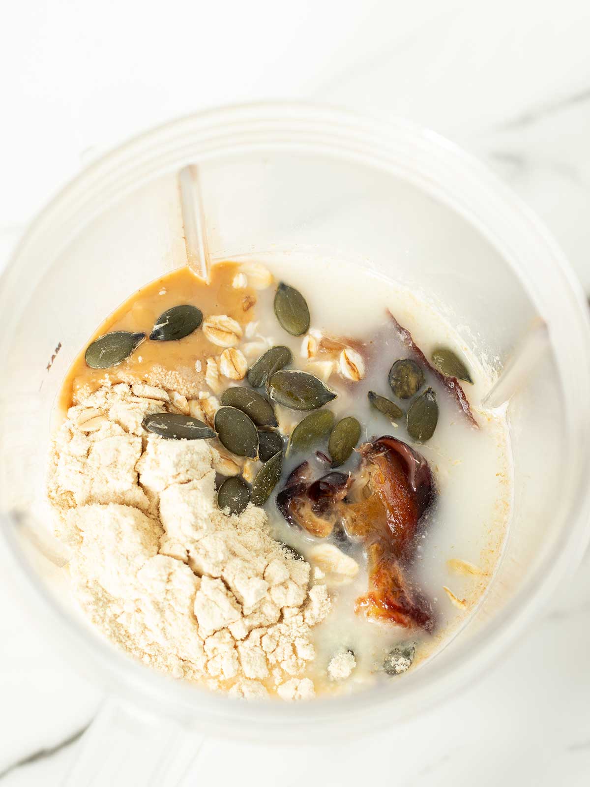 Oatmeal date protein shake ingredients in blender.