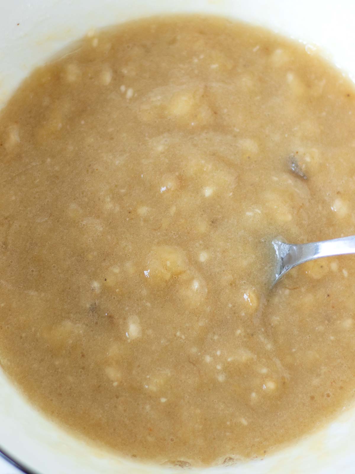 Wet ingredients in a bowl for vegan banana chickpea flour bread.