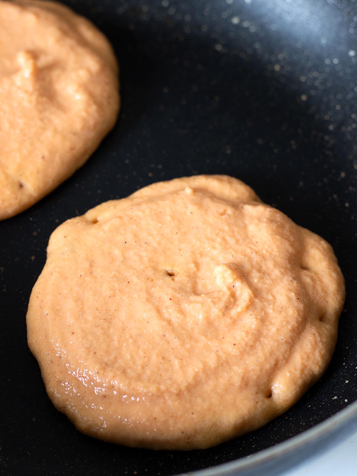 Cooking red lentil pancakes.
