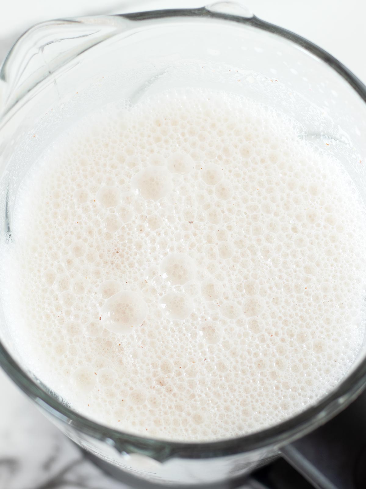Homemade almond milk in blender.