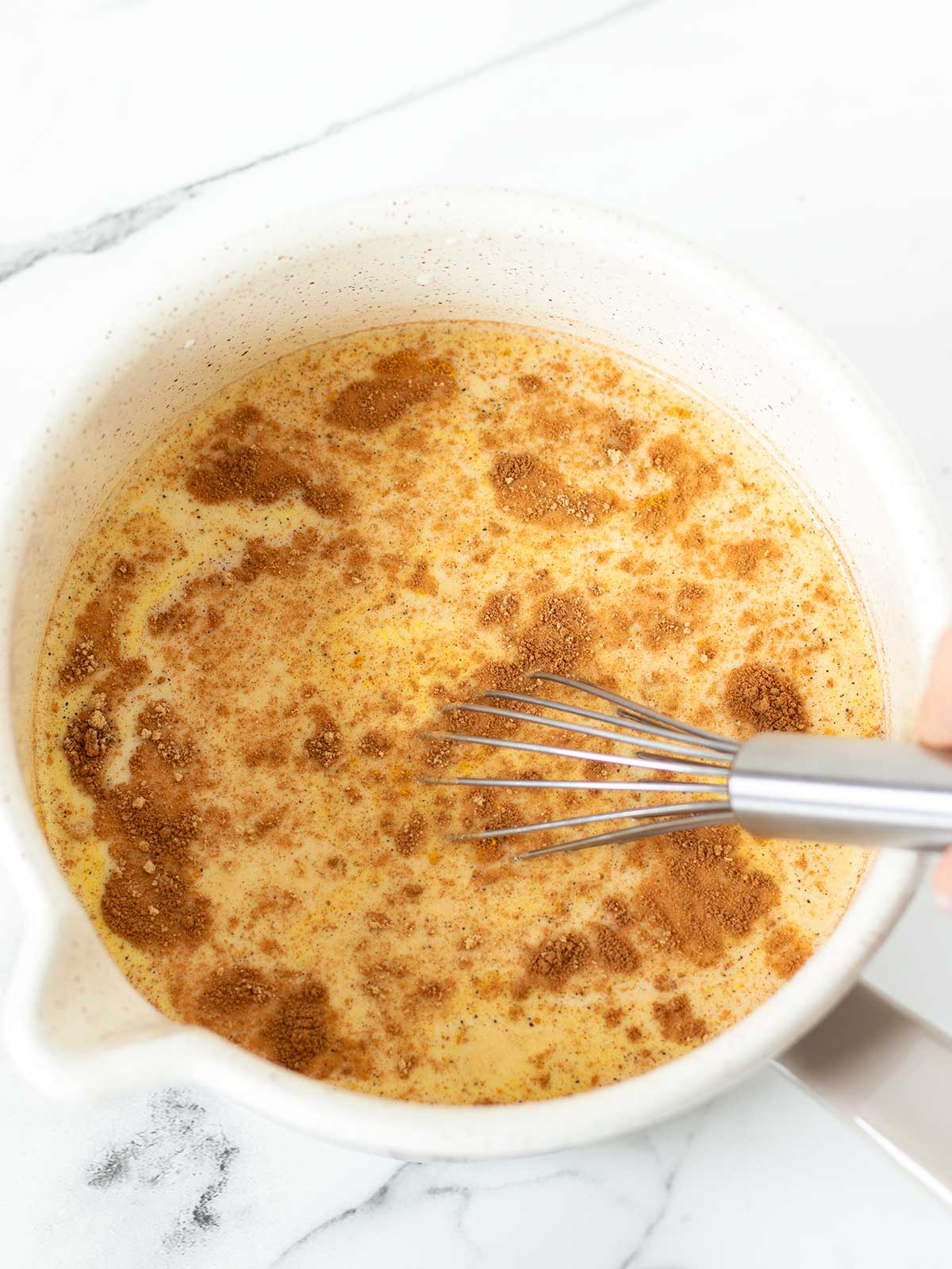 Vegan turmeric golden milk latte ingredient is saucepan.