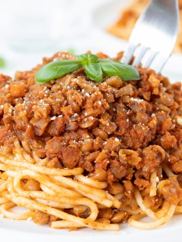 Vegan mushroom lentil bolognese pasta sauce on top of spaghetti.