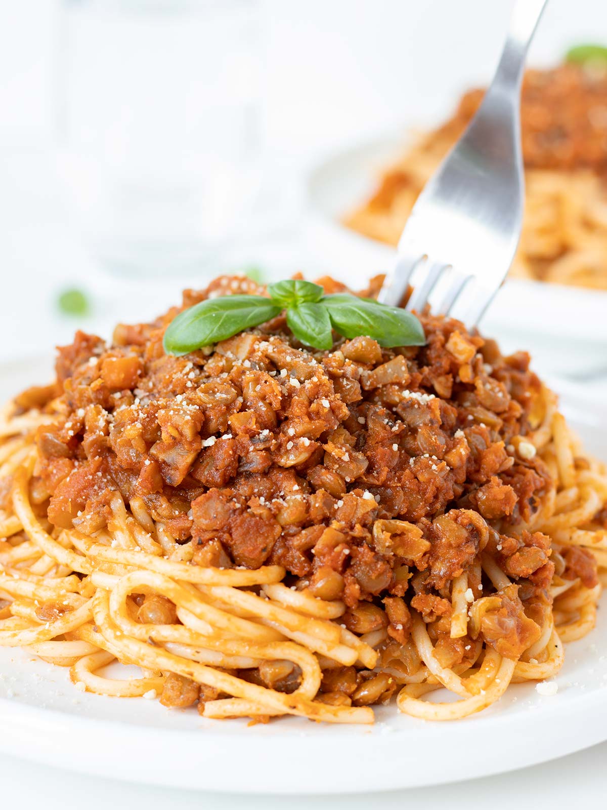 Vegan mushroom lentil bolognese pasta sauce on top of spaghetti.