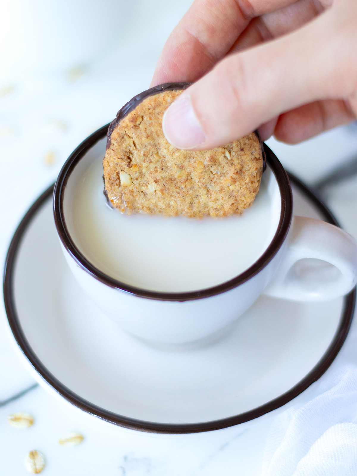 Homemade vegan oat milk with oatmeal cookie for breakfast.