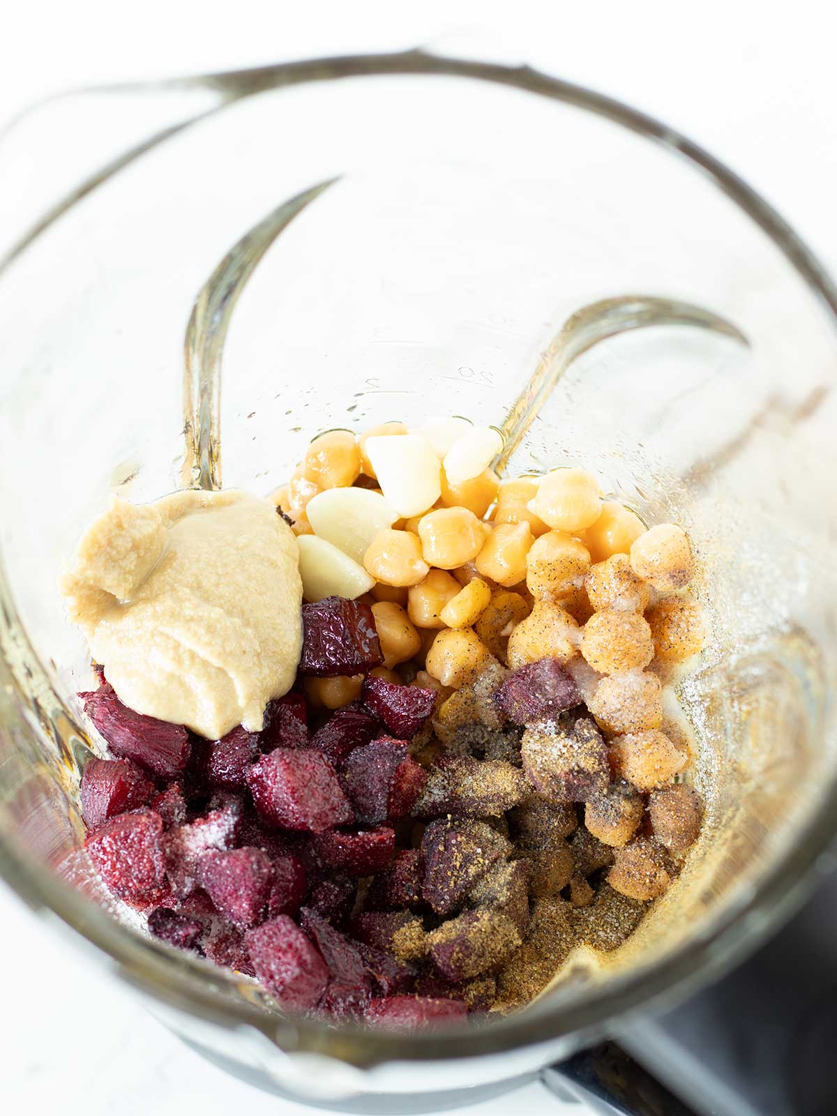 Pink beet hummus ingredients in blender.