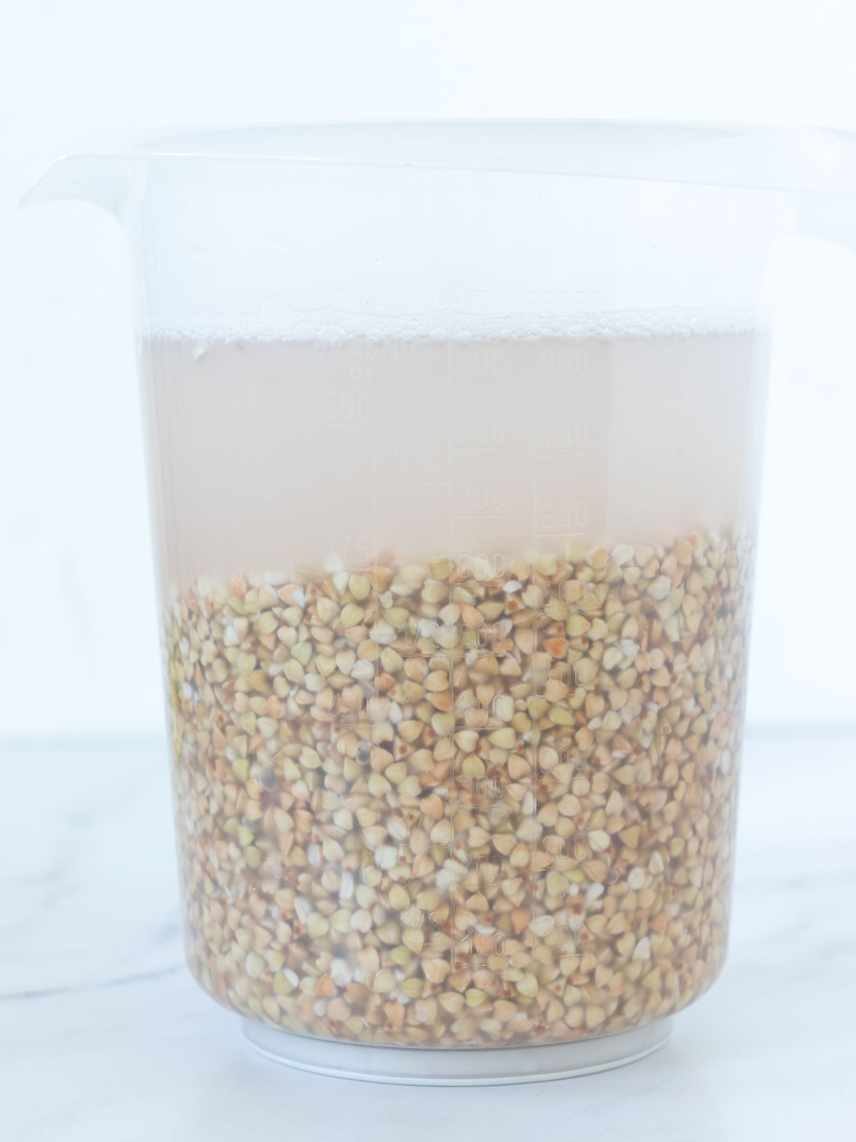 Soaking buckwheat groats for homemade gluten-free bread.