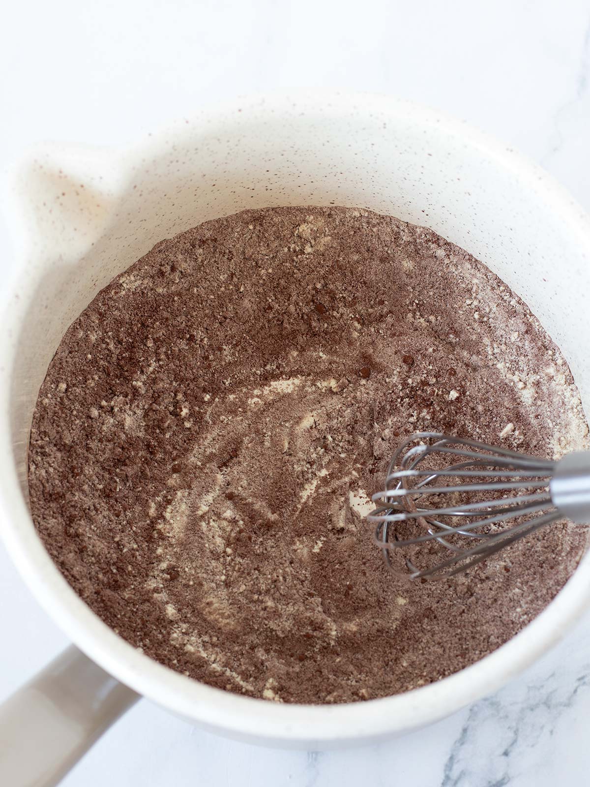 Saucepan with dry ingredients for homemade protein hot chocolate.