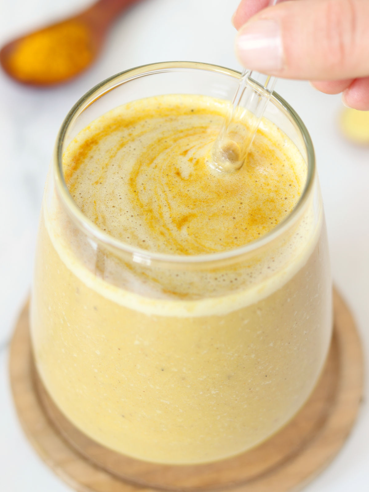 Golden milk smoothie with turmeric powder.
