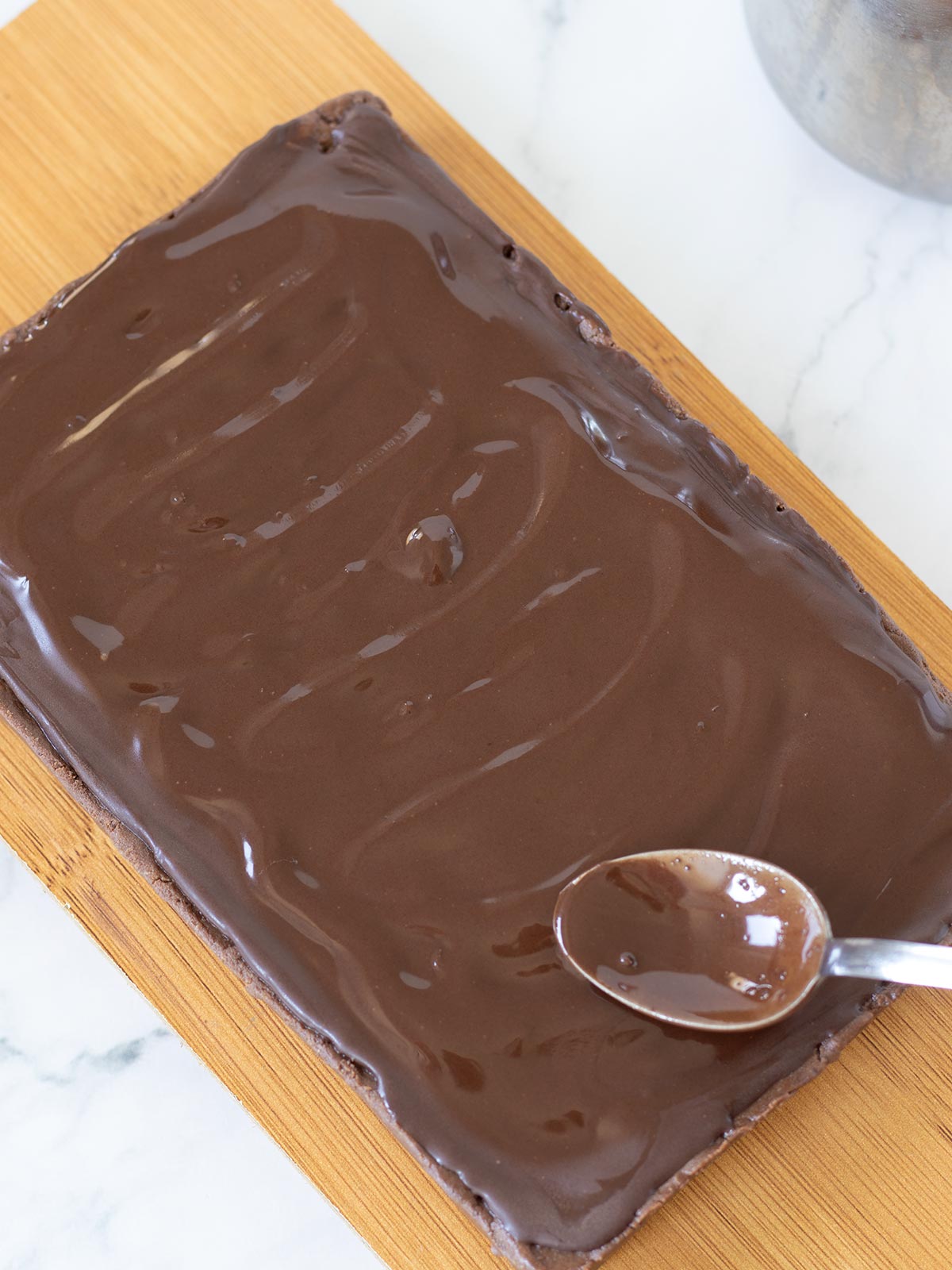 Melted chocolate on top of homemade protein brownie bars.