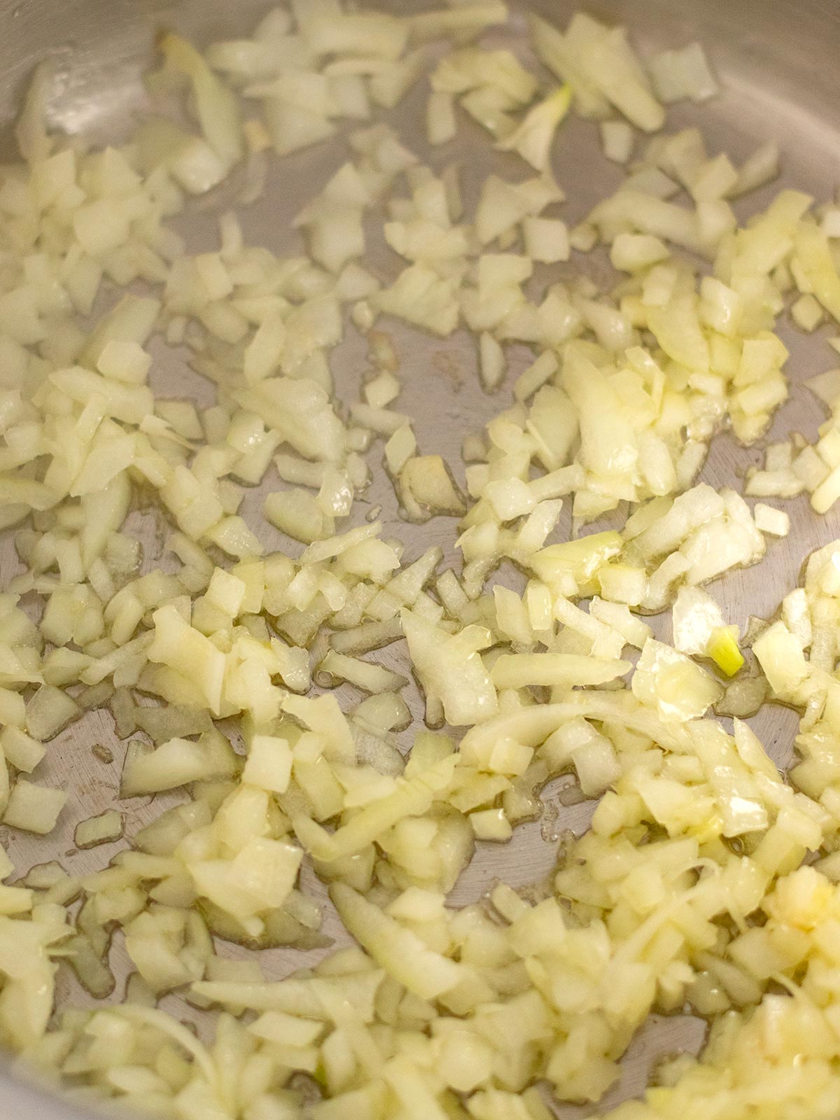Sauteing onions for green peas curry.