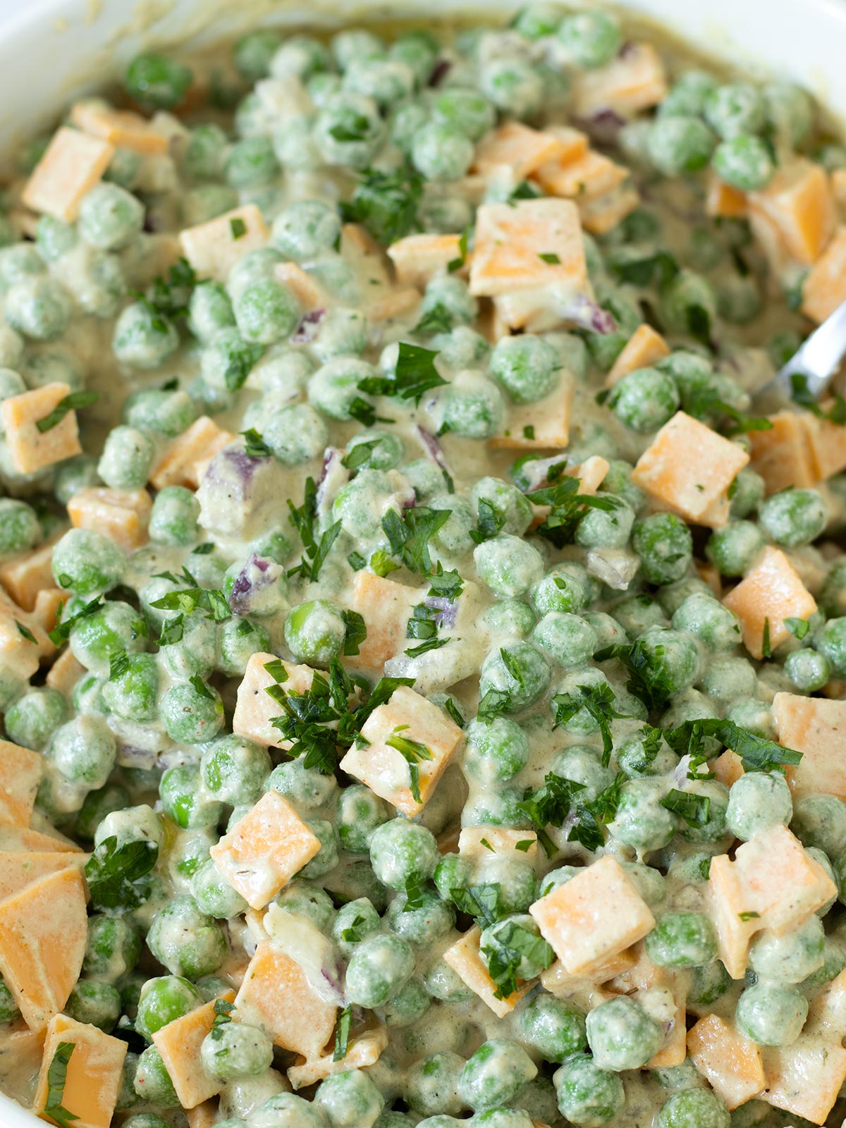 Vegan green pea salad with cheddar cheese.