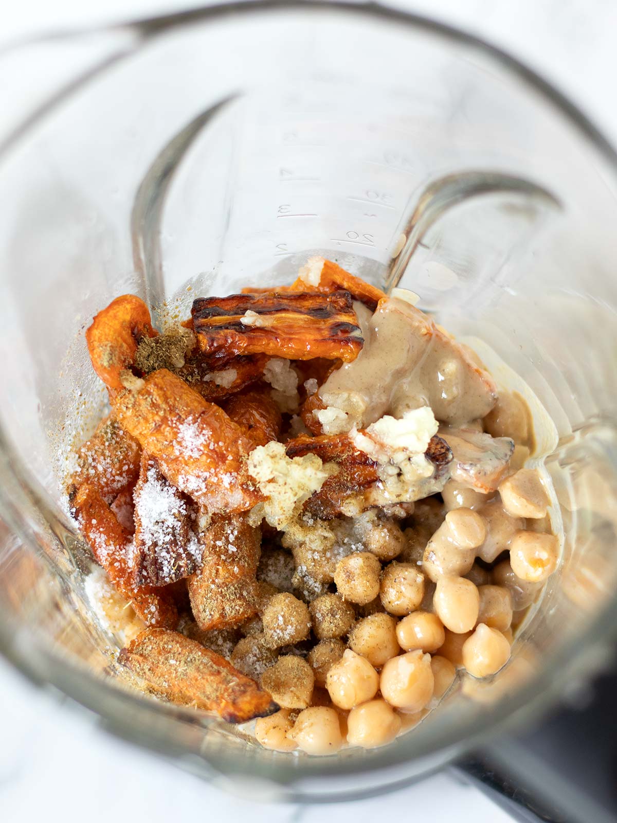 Carrot hummus ingredients in a blender.