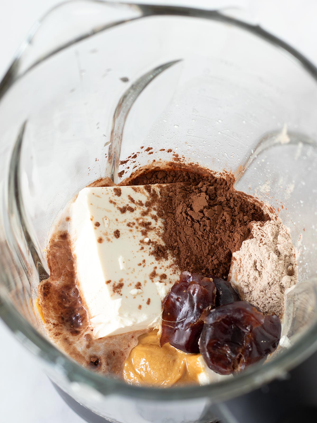 Chocolate silken tofu smoothie ingredients in blender.