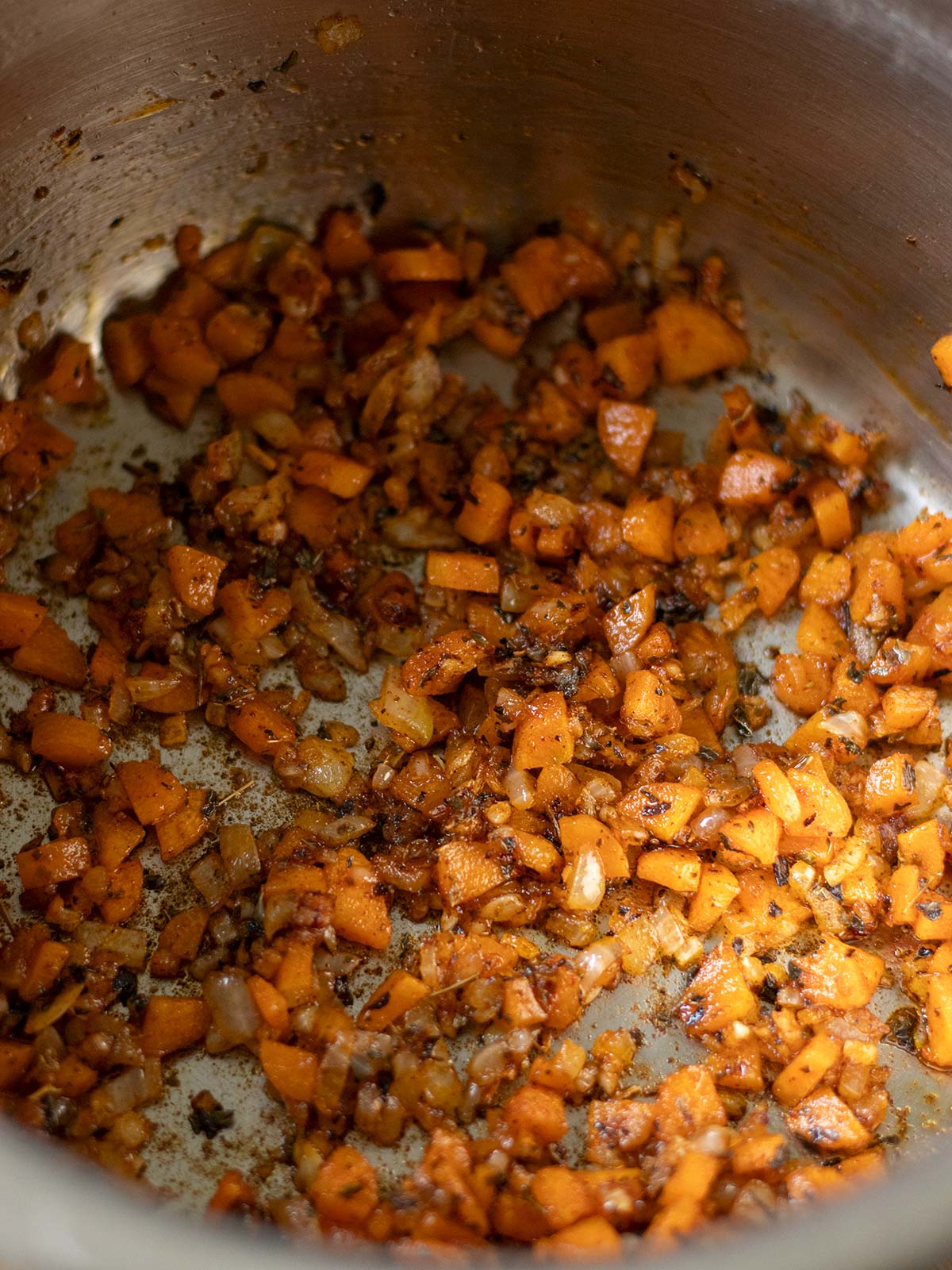 Cooking aromatics for red lentil pasta recipe.