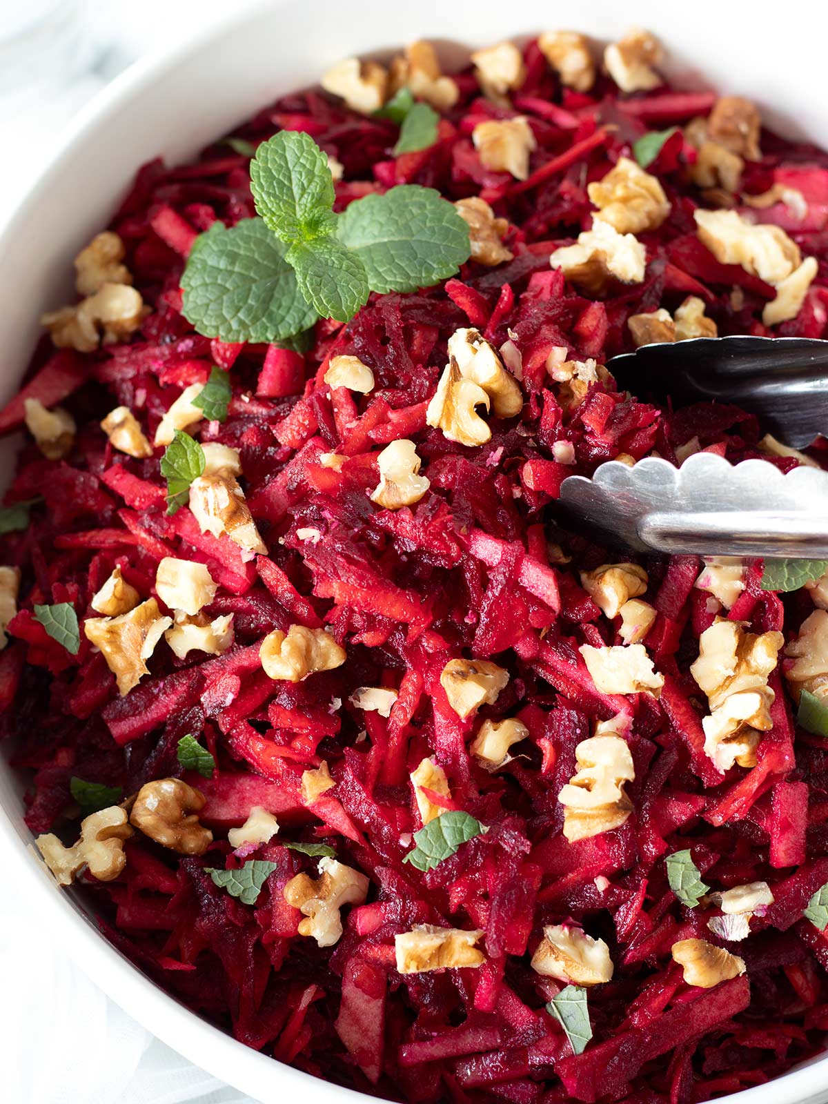 Raw beet carrot apple salad with walnuts.