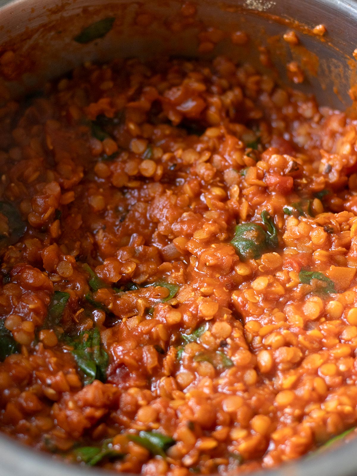 High-protein red lentil tomato pasta sauce with spinach.