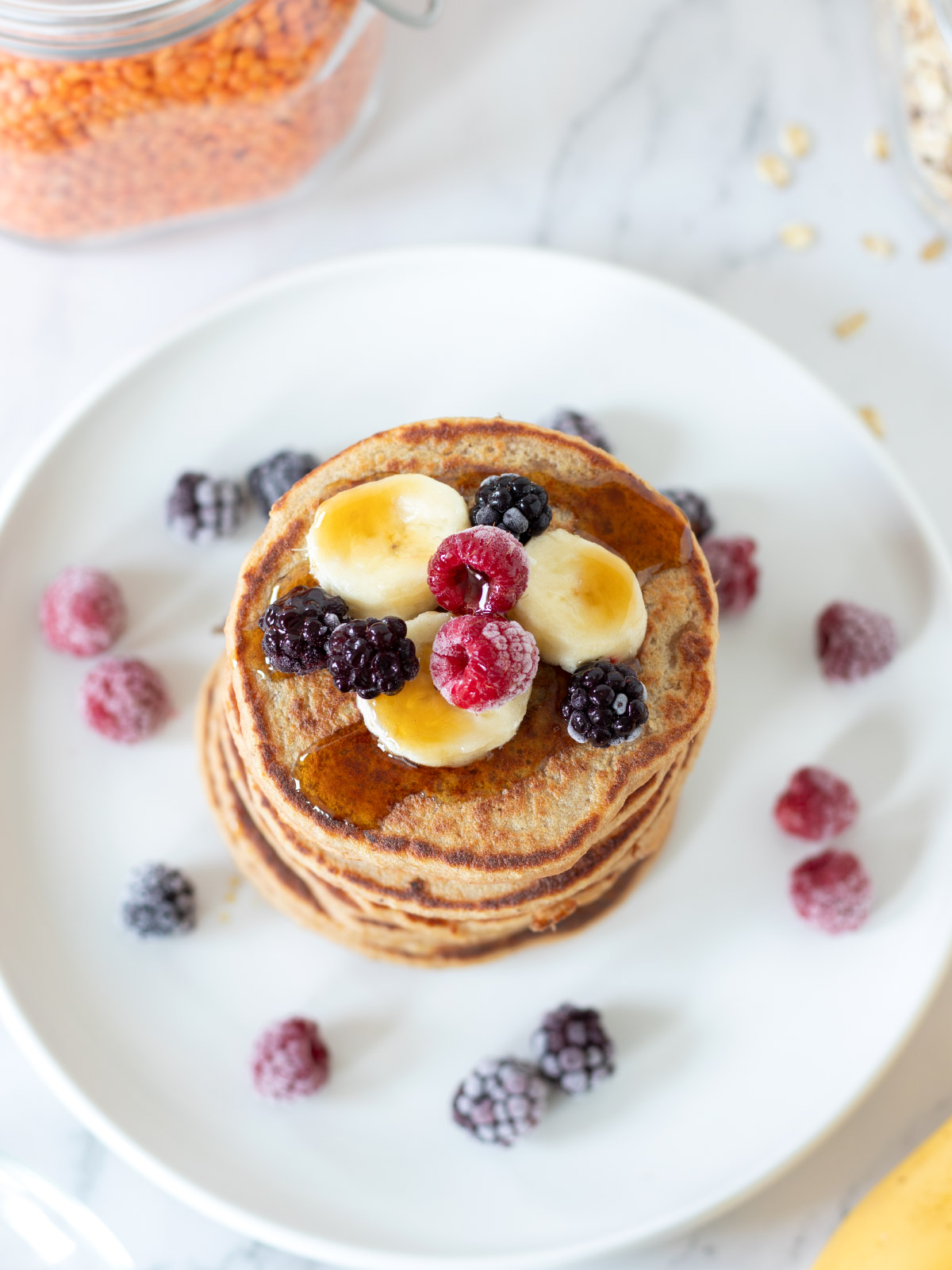 Stack of vegan high-protein red lentil banana pancakes with oats.