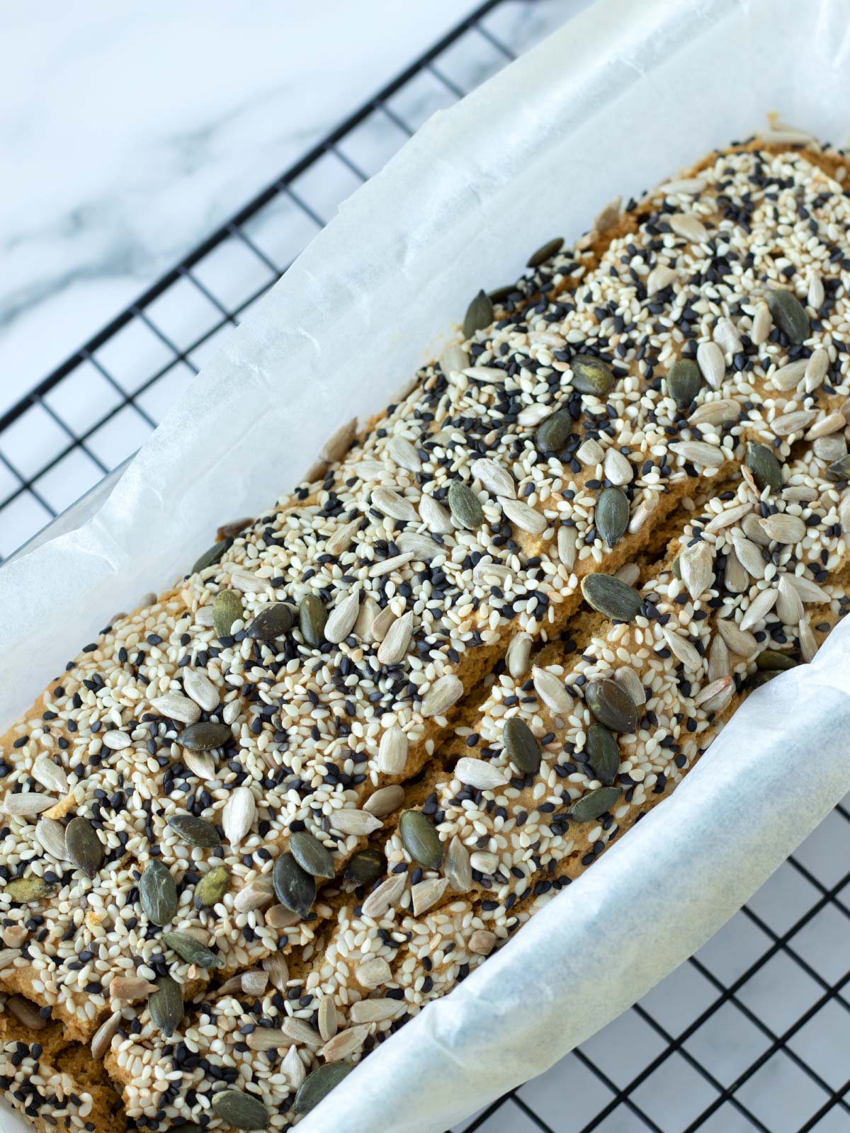 Freshly baked chickpea flour bread topped with seeds.