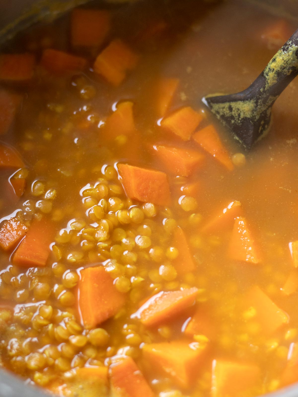 Cooking red lentil sweet potato soup.